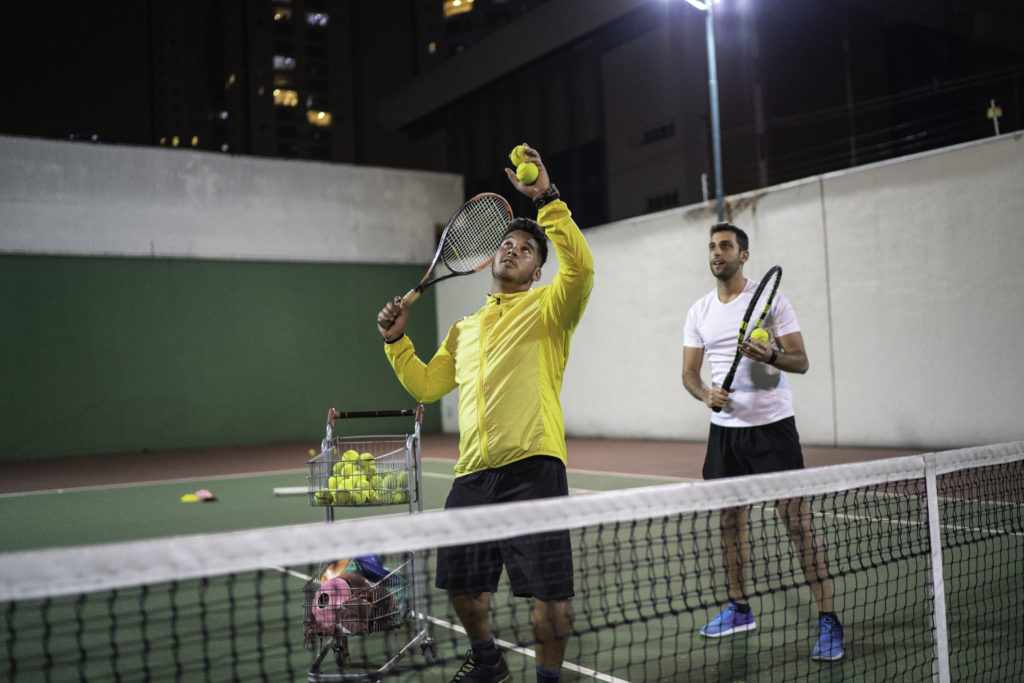 Teaching a guy how to play tennis