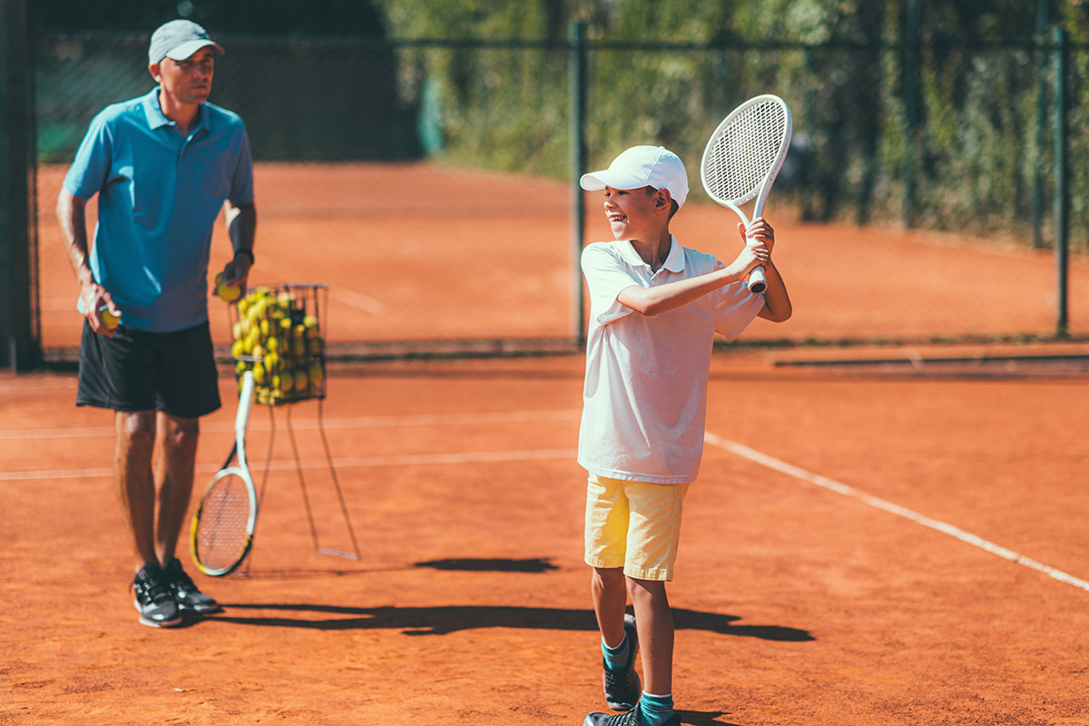 Tennis Lesson with Boy and Trainer